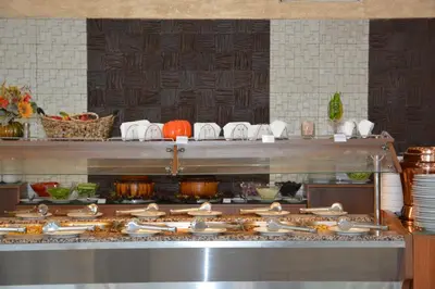 a kitchen with a bunch of food on a counter at Hotel Neva in Kiten