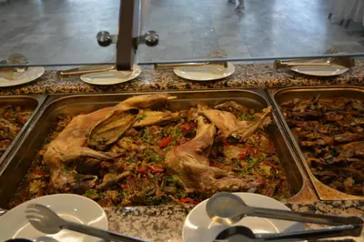 a table with a tray of food on a counter at Hotel Neva in Kiten