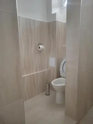 a bathroom with a toilet and a shower stall at Guesthouse Oasis in Kiten