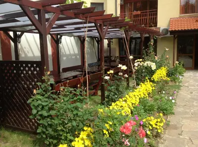 a garden of flowers in front of a building at Condo Hotel Valentina in Obzor