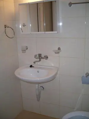 a bathroom with a sink and a mirror and a toilet at Condo Hotel Valentina in Obzor