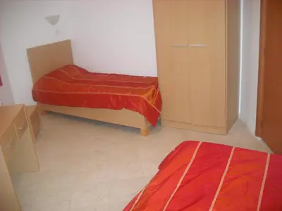 a small room with two beds and a closet at Vega Village Ap B39 in Sveti Vlas