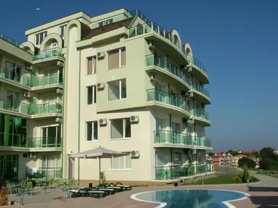 a building with a pool in front of it at Samara Apartment in Lozenets