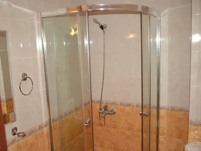 a shower with a glass door in a bathroom at Samara Apartment in Lozenets