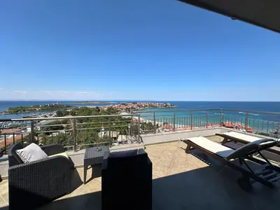 a balcony with chairs and a view of the ocean at Family Hotel Radiana in Sozopol