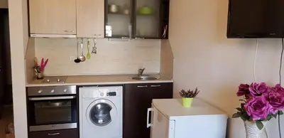 a small kitchen with a washing machine and a sink at Family Aparthotel Vintegra in Burgas City