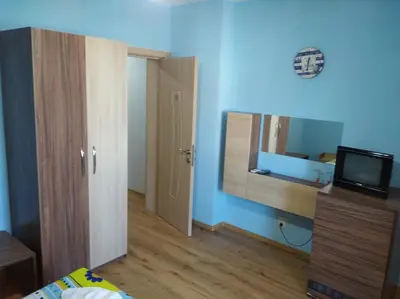 a room with a bed and a mirror on the wall at Guest House Niya Chernomorets in Chernomorets