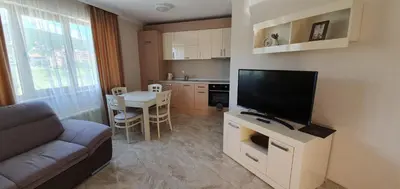 a living room with a couch and a flat screen tv at VILLA FLORENCE Boutique Apart Hotel in Sveti Vlas