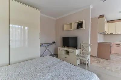 a bedroom with a bed and a tv and a chair at VILLA FLORENCE Boutique Apart Hotel in Sveti Vlas