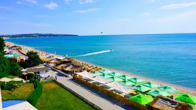 an aerial view of a beach with umbrellas and the ocean at Aurora apartments on the beach in Obzor