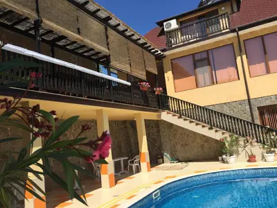 a house with a swimming pool in front of a building at Complex Terazini in Byala