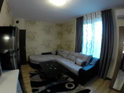 a living room with a couch and a window at VIP Apartments Dobrevi in Primorsko