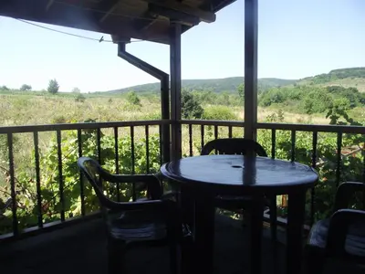 a table and chairs on a balcony with a view at Lozyata Guest House in Obzor
