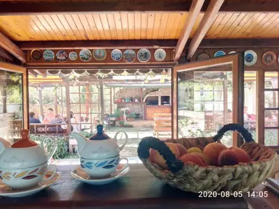 a bowl of fruit sitting on a table with a tea pot at Lozyata Guest House in Obzor
