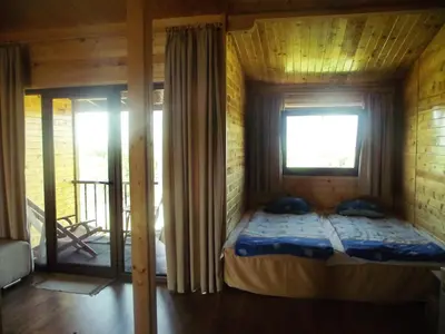 a bedroom with a bed in a room with a window at Lozyata Guest House in Obzor