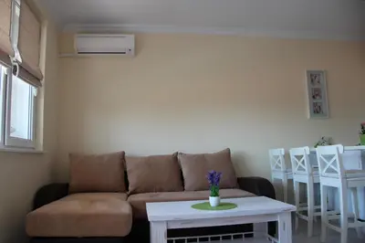 a living room with a couch and a table at Karchevi Apartment in Sveti Vlas