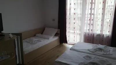 a bedroom with two beds and a window at The Sea Lions Guest House in Tsarevo