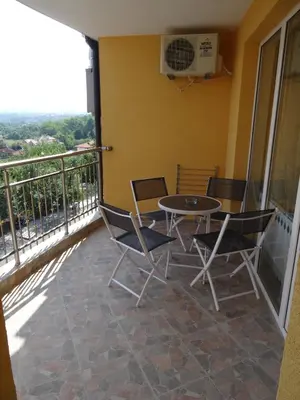 a balcony with a table and chairs on it at The Sea Lions Guest House in Tsarevo