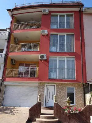 an apartment building with a red at The Sea Lions Guest House in Tsarevo