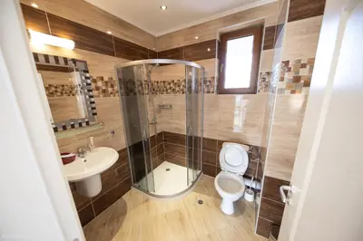 a bathroom with a shower and a toilet and a sink at Villas in Complex Trakiyskiy Bryag in Lozenets