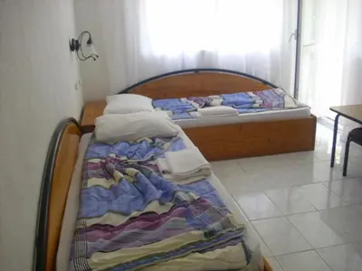 a bed in a room with a bed sidx sidx sidx at Lurd Family Hotel in Lozenets