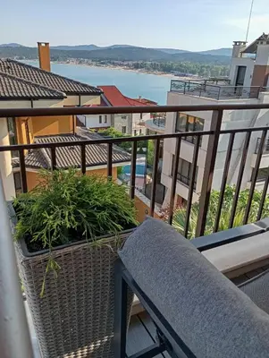 a balcony with a bench and a view of the water at Apartments Provence in Sozopol