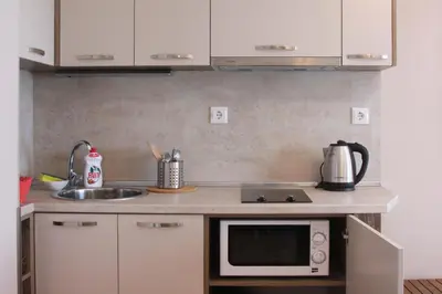 a kitchen with a sink and a microwave at Beach Apartment MELINA in Pomorie