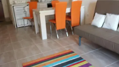 a living room with a couch and a table and chairs at Apartments Resort BG in Primorsko