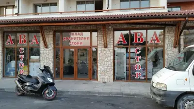 a scooter parked in front of a building at Apartments Resort BG in Primorsko