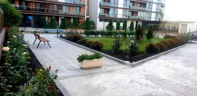 a courtyard in a building with a bench and plants at Apart Hotel Iglika in Pomorie
