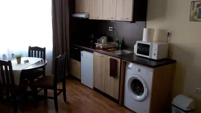 a kitchen with a washing machine and a microwave at Villa Maria in Tsarevo