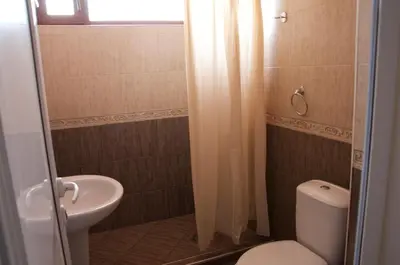 a bathroom with a toilet and a sink at Villa Maria in Tsarevo