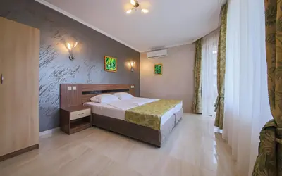 a bedroom with a large bed in a room at Guesthouse Phoenix in Obzor