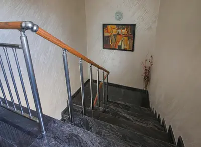 a stairway with a painting on the wall and a picture at Guesthouse Phoenix in Obzor
