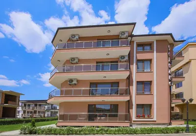 an apartment building with balconies on the side at Guesthouse Phoenix in Obzor
