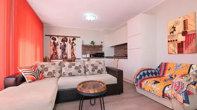 a living room with a couch and a chair at Flat Lora Pomorie in Pomorie