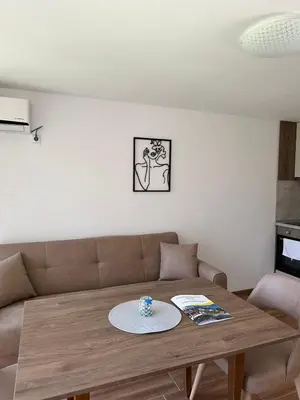 a living room with a couch and a wooden table at Complex Fichoza in Varna City