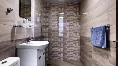 a bathroom with a sink and a toilet and a mirror at Complex Fichoza in Varna City