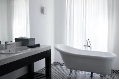 a white bathroom with a sink and a bath tub at Sea Sense Boutique Villa & Relax Zone in Sozopol