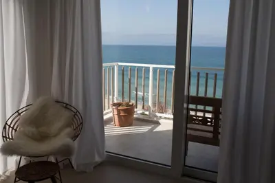 a room with a balcony with a view of the ocean at Sea Sense Boutique Villa & Relax Zone in Sozopol