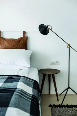 a bedroom with a bed with a lamp and a table at Sea Sense Boutique Villa & Relax Zone in Sozopol
