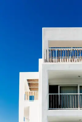 a white building with balconies and a blue sky at Sea Sense Boutique Villa & Relax Zone in Sozopol
