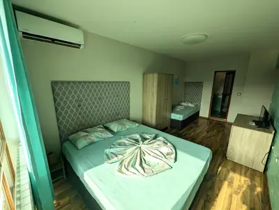 a bedroom with a large bed in a room at Guest house Sineva in Primorsko