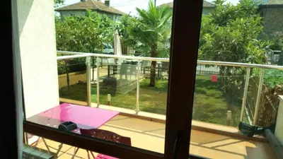 a window view of a balcony with a view of a yard at Guest house Sineva in Primorsko