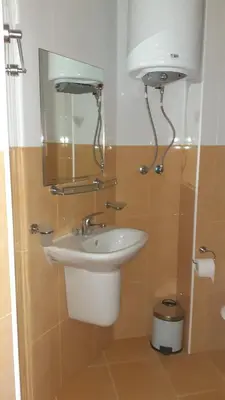 a bathroom with a sink and a toilet at Complex Oazis in Ravda