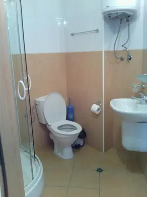 a bathroom with a toilet and a sink and a shower at Complex Oazis in Ravda