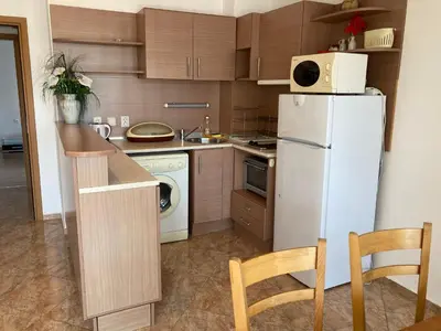 a kitchen with a white refrigerator and a dishwasher at Apartments in Complex Panorama in Sozopol