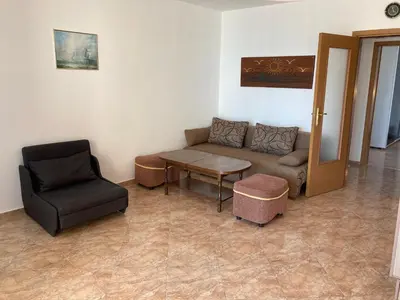 a living room with a couch and a chair at Apartments in Complex Panorama in Sozopol