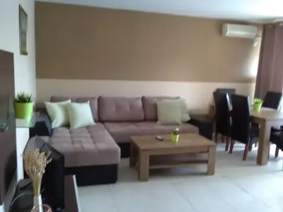 a living room with a couch and a table at Apartments in Complex Panorama in Sozopol