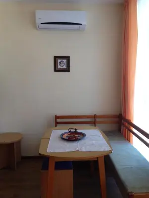 a small room with a table and a bed at Guest House SNG in Nesebar